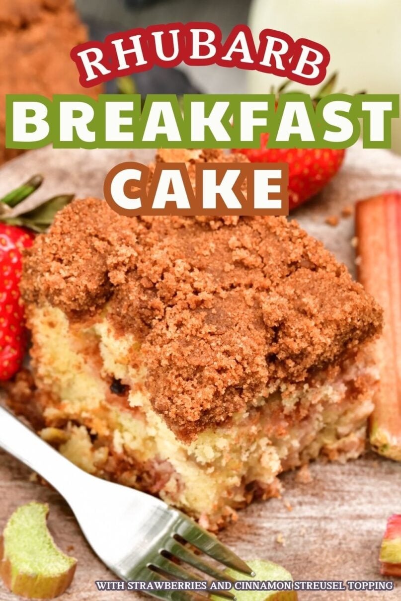 Square slice of coffee cake on a wood platter next to a silver fork and fresh strawberries and rhubarb and a glass of milk in the background with text overlay saying Rhubarb breakfast cake